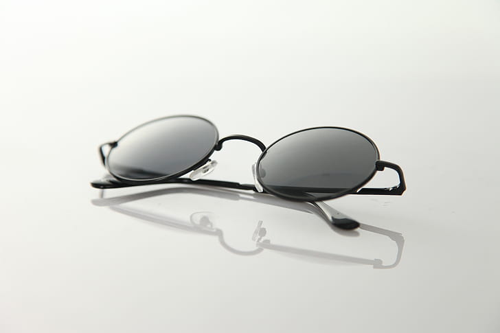 Black Frame Sunglasses on White Surface