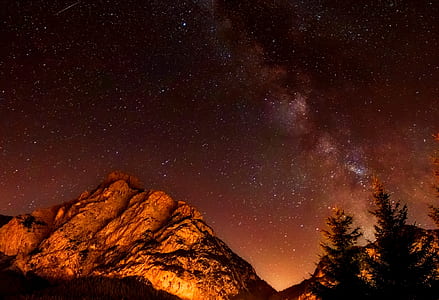 photography of mountain and sky during night time