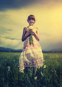 smiling girl holding white flower bouquet