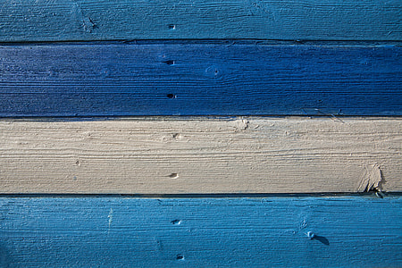 Close-up shot of blue and cream coloured wood panels, image captured in Kent, England