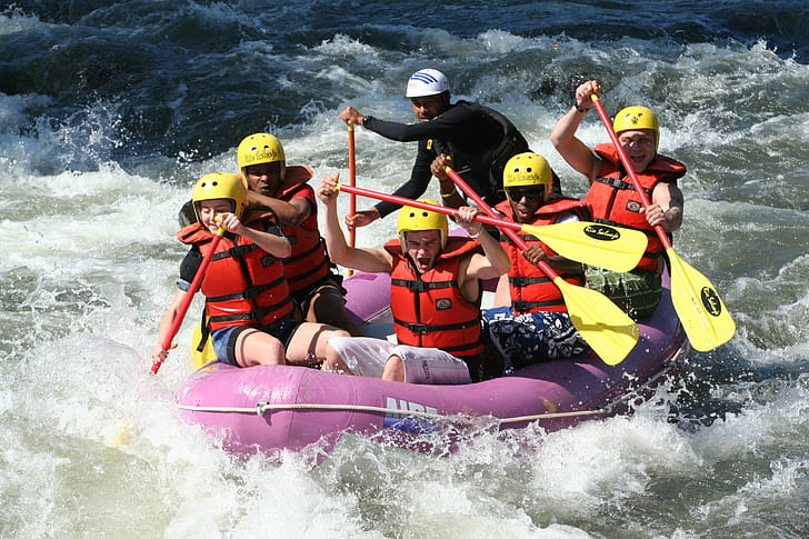 group of men water rafting