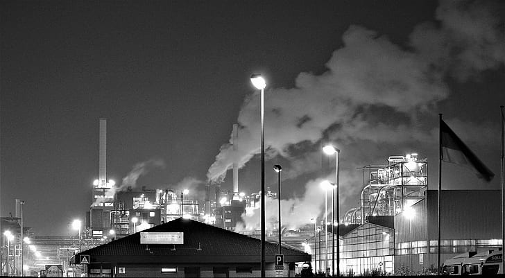 Factories creating pollution and increasing Global Warming. Busy industrial  steel mill at night pumping out smoke into the environment. Time lapse vid  Stock Photo - Alamy