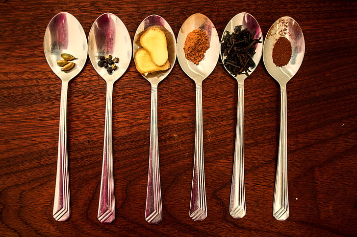six grey stainless steel spoon with spices