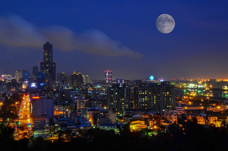 city buildings under full moon during
