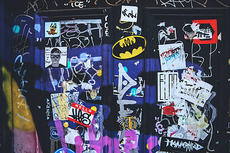 Stickers, flyers and graffiti captured on a wall in East London