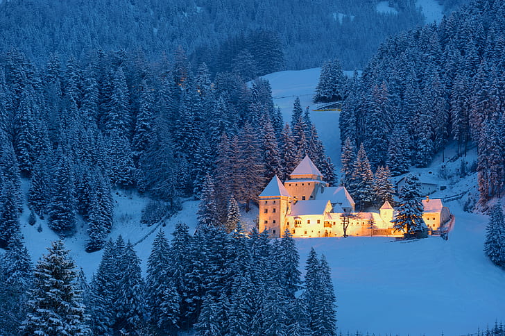white mansion in middle of snowfield with lights during day