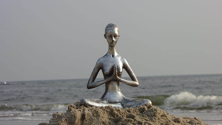 female statue near seashore