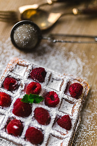 Breakfast waffles with fresh raspberries and powdered sugar