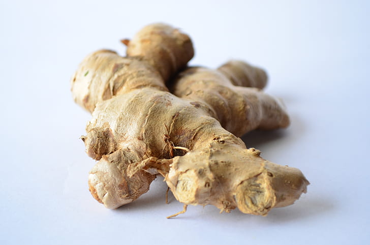 photo of ginger on top of white surface