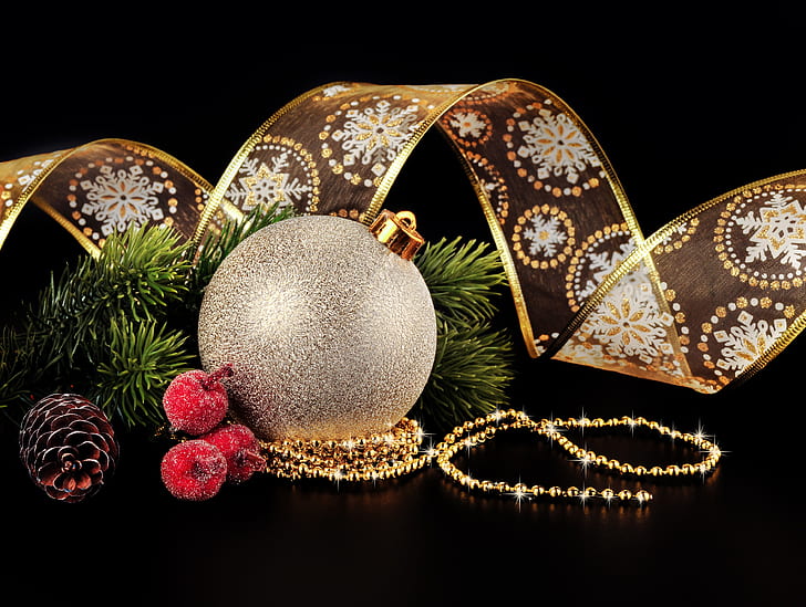 gray Christmas bauble, brown pine cone, and gold-colored ribbon