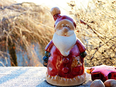 brown and red Santa Claus figurine near star ornament