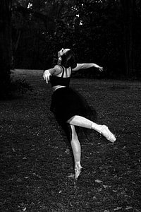 grayscale photography of ballerina woman dancing on forest