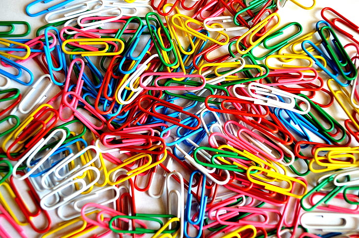 The image of paper clips of various colors. Colored paper clips