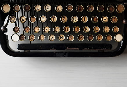 black typewriter on white wooden table