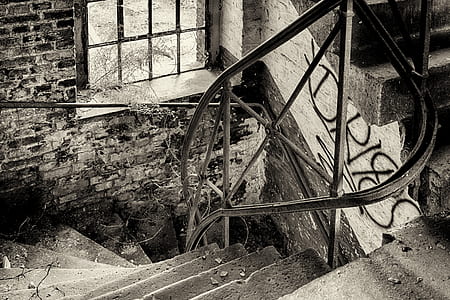 grayscale photo of spiral stair