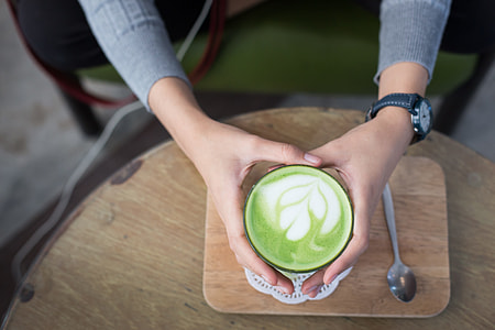 person holding latte art glass