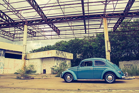 Blue Volkswagen Beetle in Front of Building