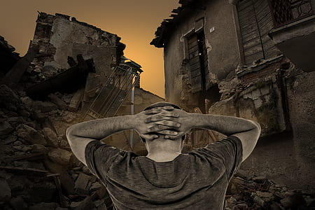 man wearing gray shirt standing near house digital wallpaper