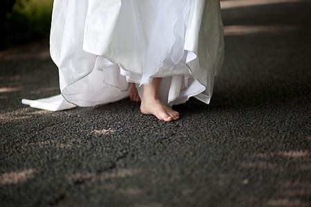 woman wearing white dress walking on black area rug