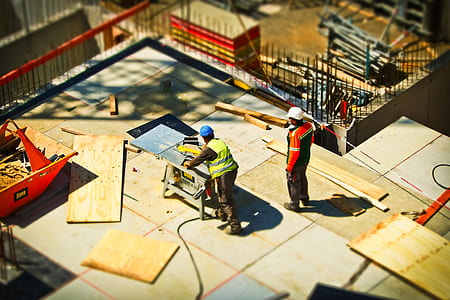 two men working in construction during daytime