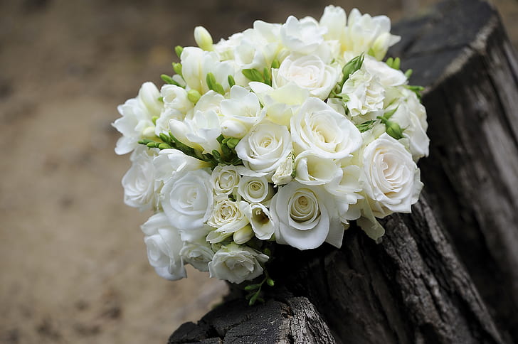 white roses bouquet on a wooden surface