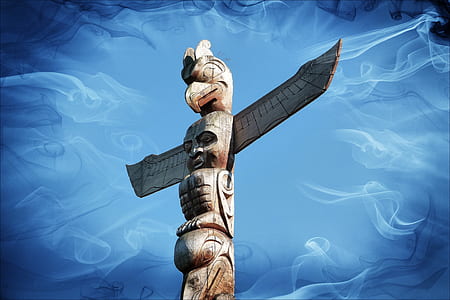 brown wooden totem with blue background