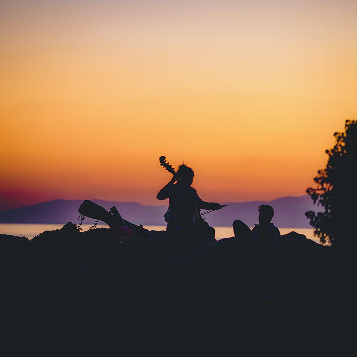 silhouette of woman playing cello