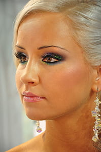 woman wearing clear dangling earrings