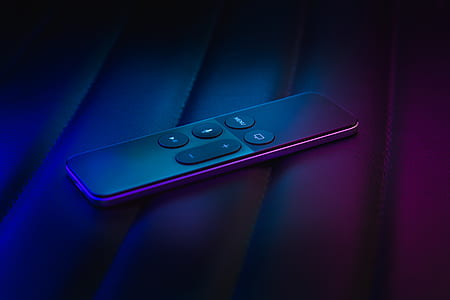 black remote controller on purple textile