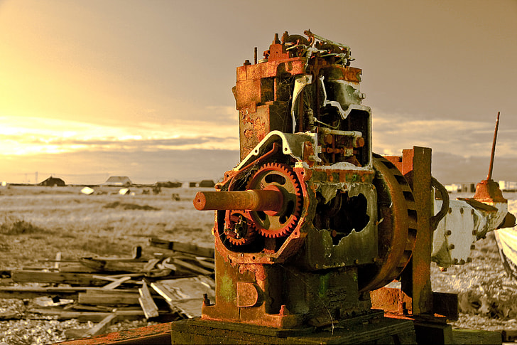 Landscape shot containing an old abandoned piece of machinery captured at sunset on the coast at Dungeness, Kent, England