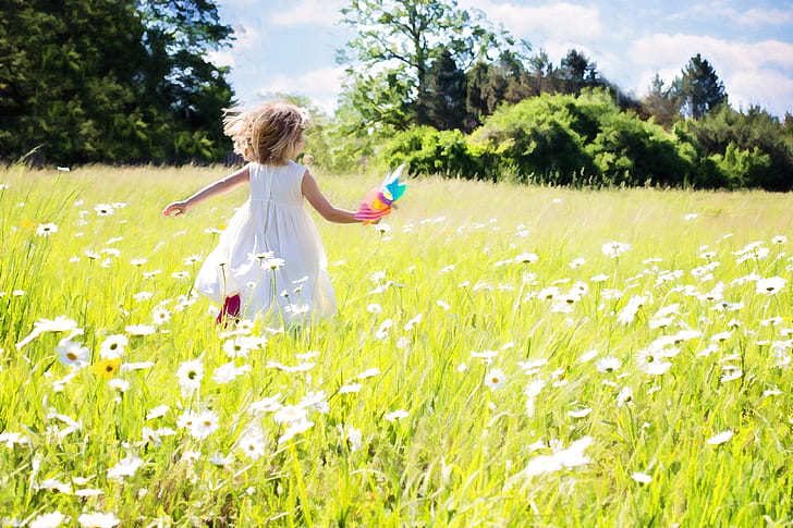 girl running in white flower field