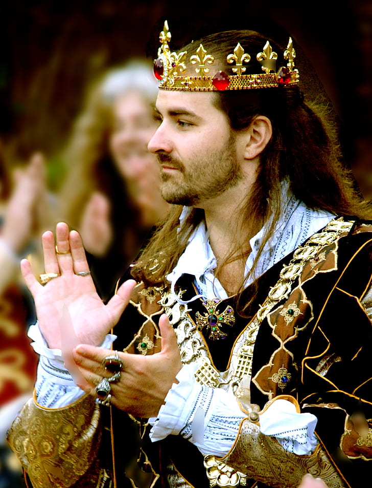 man in black and gold suit and gold crown