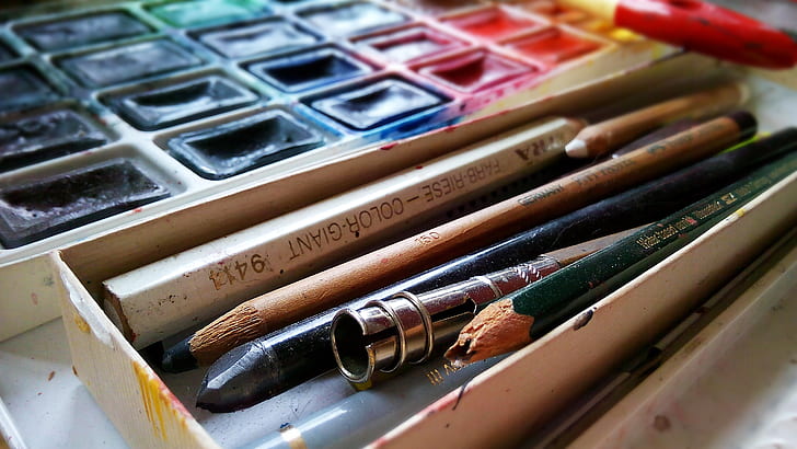assorted-color pencils on case