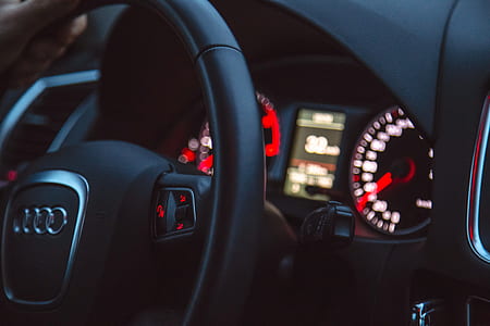 selective focus photography of black Audi steering wheel