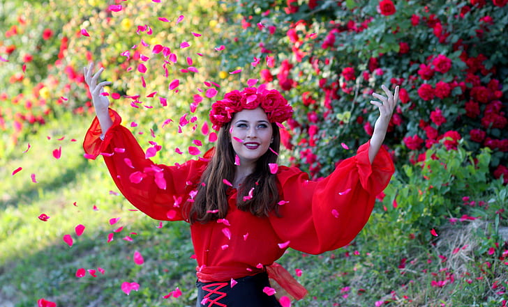 woman wearing red rose crown showering petals