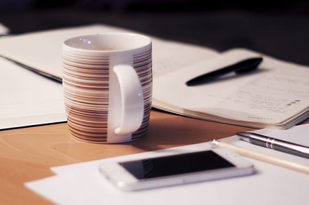 white and brown mug on table