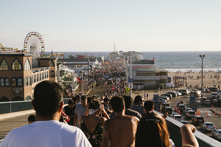 people walking toward the beach during daytime