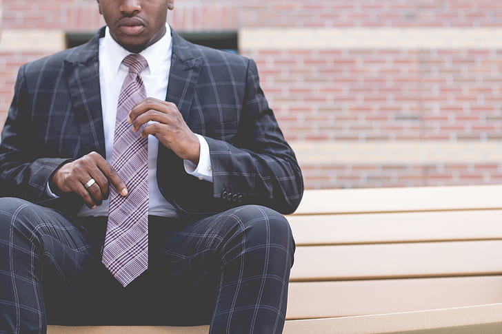 man in black and gray plaid suit set