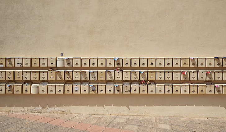 piled brown wall-mount mailboxes