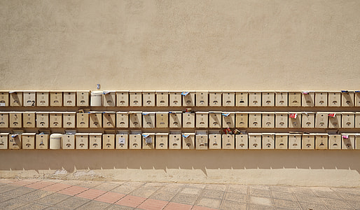piled brown wall-mount mailboxes