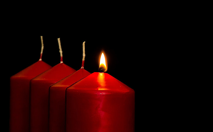 one lighted of four pillar candles