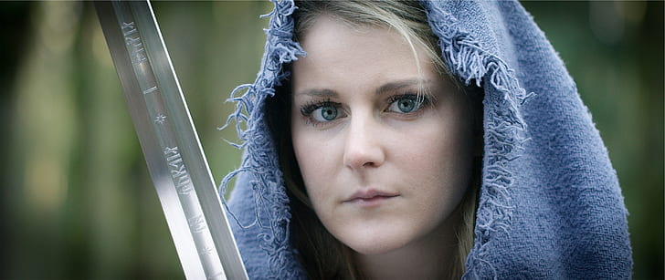 woman wearing blue hood holding gray sword