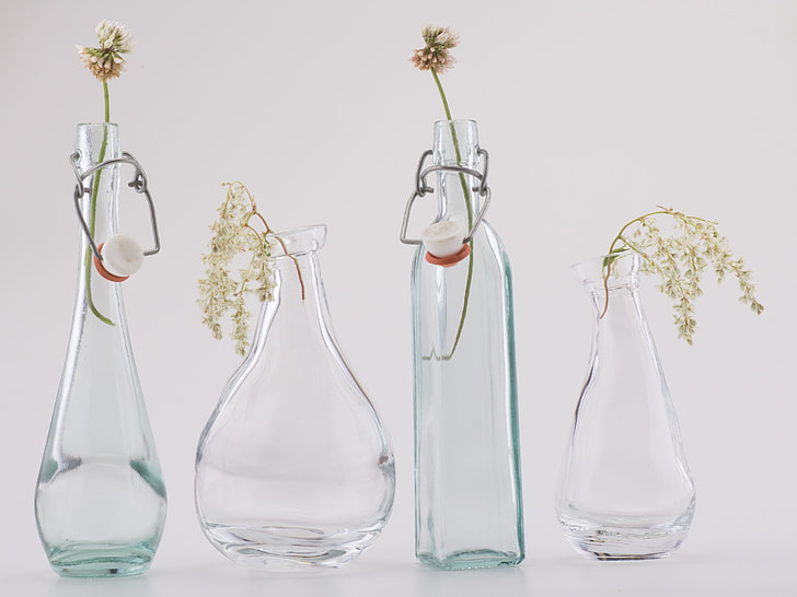 close-up photo of four clear glass vases