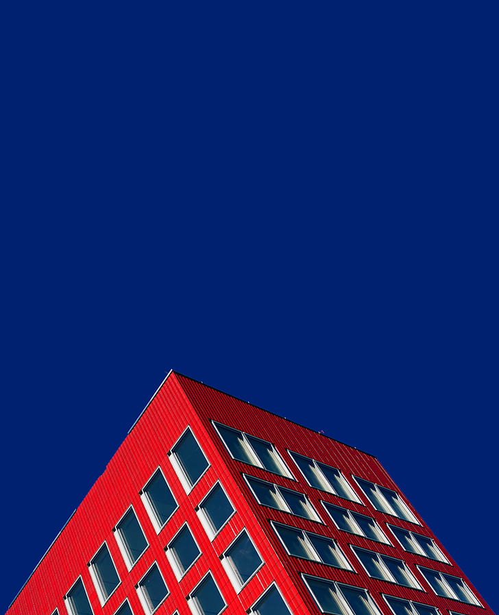 red high-rise building under blue sky