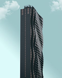 photo of black and gray curved high-rise building