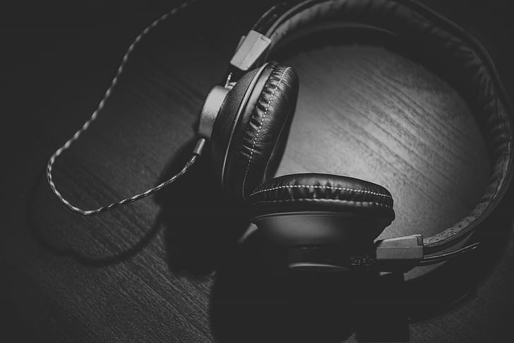 black corded headphones grayscale photo
