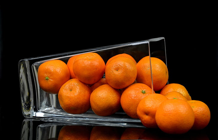 closed up photography of pile orange fruit in clear glass cup
