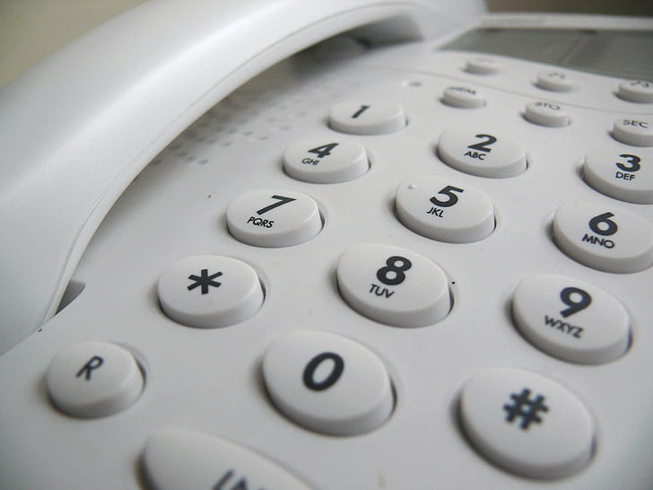 closeup photo of white telephone
