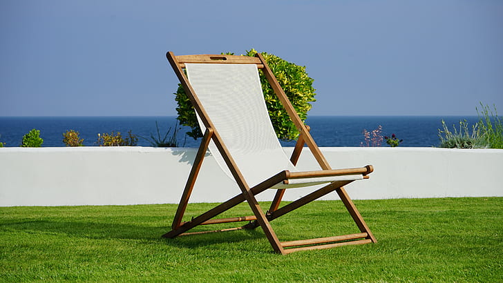 brown and white outdoor folding lounge chair under sunny sky