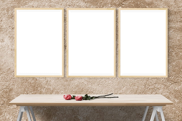 two red roses on rectangular brown wooden trestle table